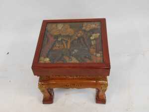 An Eastern carved hardwood coffee table, the glazed top enclosing a panel decorated with elephants and flowers, on out splayed legs, 43cm high, the top 50cm x 50cm. - 2