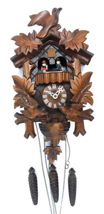 A 20thC oak cuckoo clock, with maple leaf and bird decoration, 25cm high, with weights and pendulum.