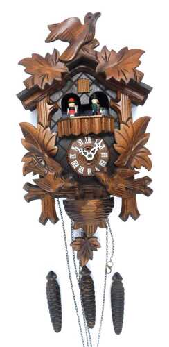 A 20thC oak cuckoo clock, with maple leaf and bird decoration, 25cm high, with weights and pendulum.