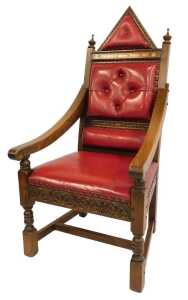 An Elizabeth II Silver Jubilee oak throne chair, with red leather upholstery, and carved and raised back, with crested and button decoration bearing gilded inscription, 150cm high, 69cm wide, 70cm deep.