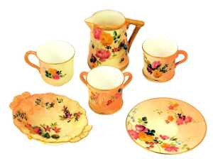A group of Royal Worcester blush ivory porcelain, comprising miniature tyg, 4cm high, jug, tea cup and saucer, coffee cup and twin handled dish.