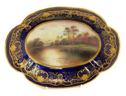 A Paragon porcelain shaped oval dish, titled 'Autumn Leaves, After Parton', decorated centrally with lake scene and trees signed F Micklewright, with a Royal blue border, gilt heightened, printed marks, 25cm wide.