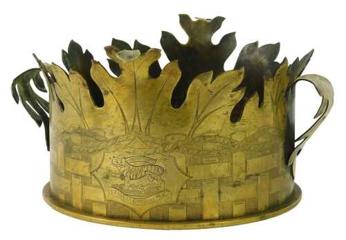 A World War One brass shell case, converted to a twin handled centrepiece with leaf carved rim, bearing engraved Leicestershire Regiment crest surrounded by engraved oblong and rope twist decoration, 15cm high, 24cm diameter.