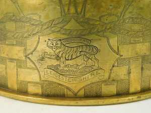 A World War One brass shell case, converted to a twin handled centrepiece with leaf carved rim, bearing engraved Leicestershire Regiment crest surrounded by engraved oblong and rope twist decoration, 15cm high, 24cm diameter. - 3