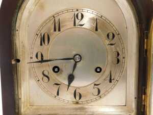 An early 20thC mahogany cased mantel clock, the silvered dial bearing Arabic numerals, Junghans eight day movement with coil strike, the case of domed form, on a moulded base raised on four feet, 30cm high. - 2