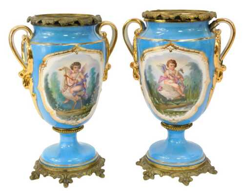 A pair of 19thC Paris porcelain twin handled vases, each with a brass leaf shaped rim and lead liner, each body decorated with a reserve depicting a cherub riding a swan to the front and floral decoration verso, against a bleu celest ground, gilt heighten