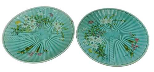 A pair of late 19thC Villeroy and Boch majolica plates, each with floral relief decoration against a turquoise ground, impressed marks and numbered 1045, 30cm diameter.