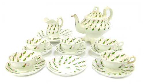 A Victorian porcelain tea service, comprising teapot, milk jug, five tea cups, six saucers, and a bread plate, each decorated with a repeating leaf pattern, the teapot, 21cm high.