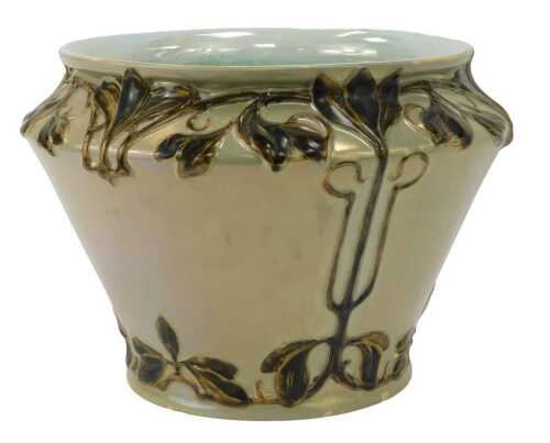 An early 20thC lustre jardiniere, with cylindrical tapering form relief decorated with leaves against a pale grey ground, 23cm high.
