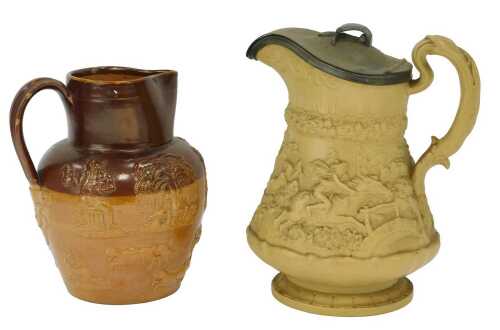 A late 19thC W Ridgway & Co relief moulded Tam O'Shanter jug, with a pewter lid, 24cm high, together with a stoneware two-tone harvest jug, relief decorated with figures, animals, etc, 20cm high. (2)