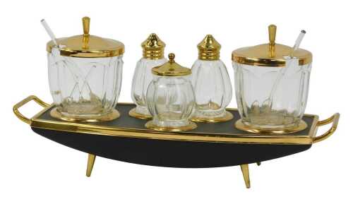 A mid century Golden Age Giftware cruet, comprising salt and pepper shaker, a pot with lid, and two condiment pots, and a black rectangular stand, boxed.