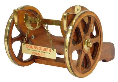 A Courvoisier Cognac bottle stand, modelled as a cannon carriage, 14cm high, 17cm wide.