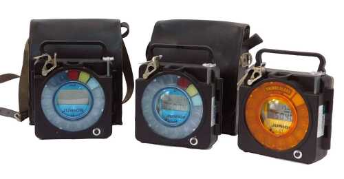 Three Thimbleless Junior pigeon timing clocks, in black plastic casing, 20cm high, two in a leatherette case.