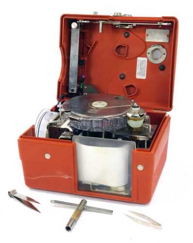 A Benzing pigeon timing clock, in burnt orange casing, model 261-262,19cm high, with outer polystyrene box.