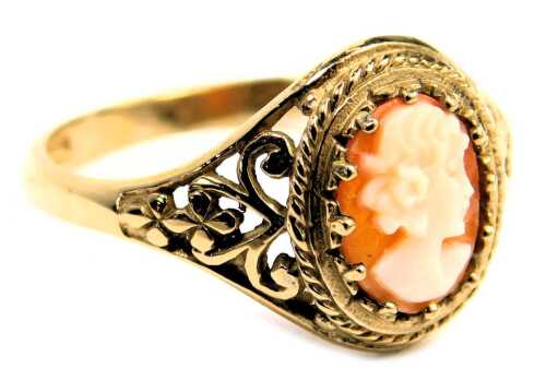 A 9ct gold shell cameo dress ring, the oval cameo claw set, with scroll floral shoulders, ring size N&frac12;, 2.2g all in.