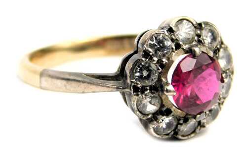 A paste stone set cluster ring, set with pink and white paste stones in floral cluster, in a silver setting, on a yellow metal band stamped 9ct silver, ring size P&frac12;, 2.9g all in.