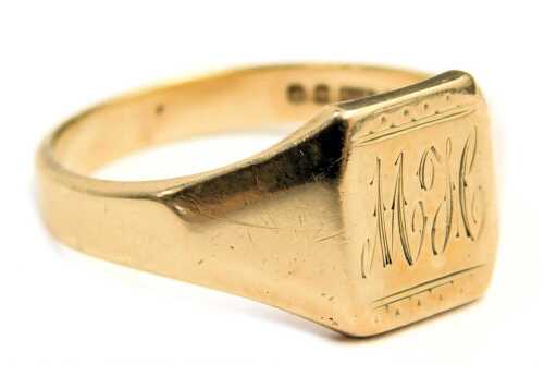 A 9ct gold signet ring, the rectangular panel bearing the initials MJC, on a plain band with rear inscription BR, Birmingham 1955, ring size X, 5.3g.