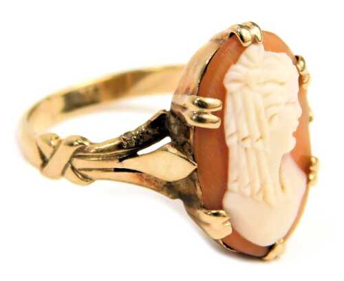 A cameo dress ring, the oval cameo depicting a maiden looking dexter, in double claw raised basket setting, on V splayed shoulders, yellow metal stamped 9ct, ring size L&frac12;, 2.5g all in.