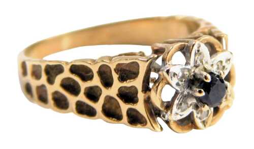 A sapphire and diamond dress ring, the floral cluster set with a central sapphire surrounded by six illusion set diamonds, in white gold, pierced border with bark effect shoulders, yellow metal, unmarked, ring size L&frac12;, 2.8g all in.