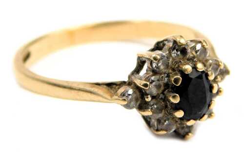 A 9ct gold floral cluster dress ring, set with cz and a central moonstone, claw set, ring size P&frac12;, 2.4g all in.