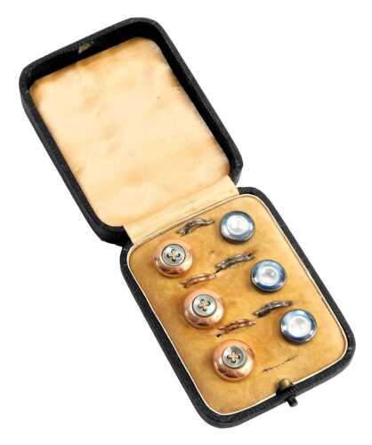 A cased gentleman's collar stud set, comprising three gold coloured and mother of pearl centered cross buttons and three white metal and mother of pearl buttons, in fitted case. (6)