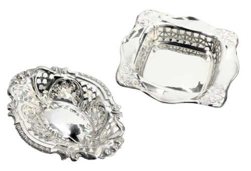 An Edward VII silver sweetmeat dish, of pierced and embossed floral oval form, Birmingham 1902, together with a George V silver dish, of serpentine square form, with pierced floral decoration, Birmingham 1919, 2.0oz. (2)