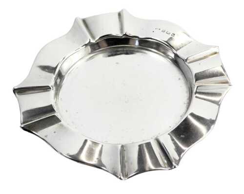 A George V silver ashtray, fluted border, maker WM, Birmingham 1931, 2.11oz.