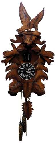 A 20thC cuckoo clock, with circular dial bearing Roman numerals, quartz movement, in an elaborate leaf carved case surmounted by an eagle in flight with hanging weights, and pendulum, the clock 64cm high.