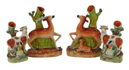 A pair of 19thC Staffordshire pottery spill vases, modelled as a stag, and a deer and fawn, each 20cm high, together with two smaller examples depicting maidens milking cows, 15cm high. (AF)