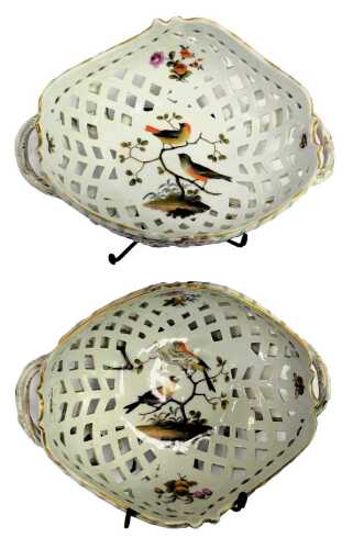 A pair of 19thC Meissen porcelain two handle baskets, each of lattice work design, decorated centrally with birds on branches, and flowers, gilt heightened, raised on four outswept feet, crossed swords marks, 26cm wide. (AF)