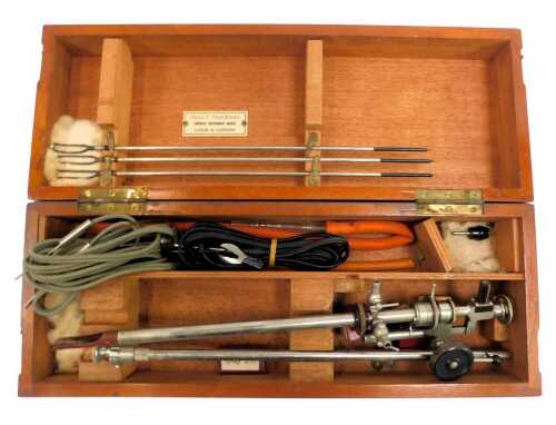 An early 20thC Cystoscope, by Charles F Thackeray, contained in a mahogany case, 38cm wide.