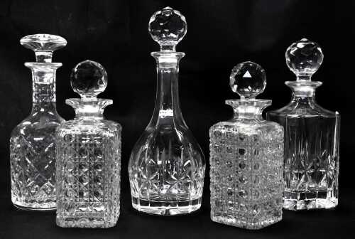 Five 20thC decanters, to include a cut glass decanter and stopper of bottle form, 30cm high, and a pair of cut glass square decanters and stoppers, 22cm high, etc.