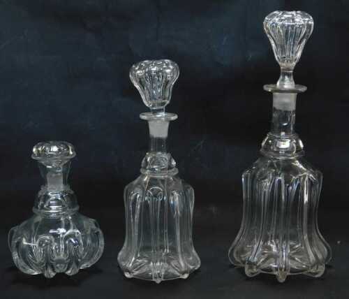 A Georgian mallet shaped decanter and stopper, 35cm high, another similar, 29cm high, and a further squat example, 18cm high.