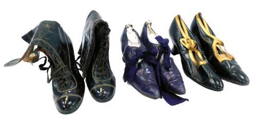 Three pairs of Victorian shoes, comprising a purple leather pair of pointed shoes with ribbon laces, a pair of black with gild trim leather shoes, and a pair of black leather boots.