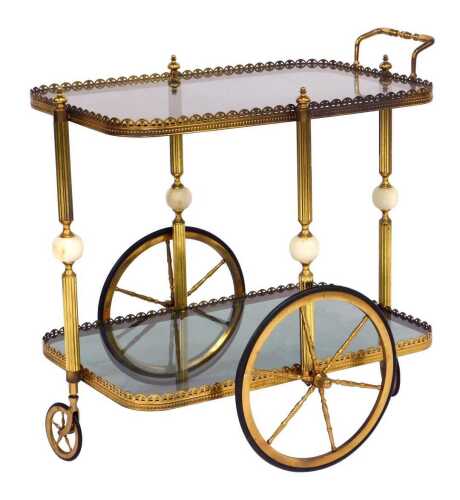 A mid century two tier brass framed drinks trolley, with two glass shelves, each shelf united by a reeded brass column with central white marble orb, on two large and two small wheels, 70cm high, 64cm wide, 42cm deep.