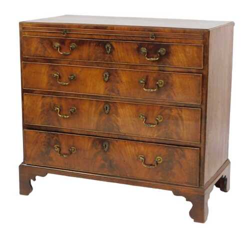 An early 19thC mahogany and flame mahogany chest, with bush slide above four graduated drawers, on bracket feet, 86cm high, 90cm wide, 46cm deep.