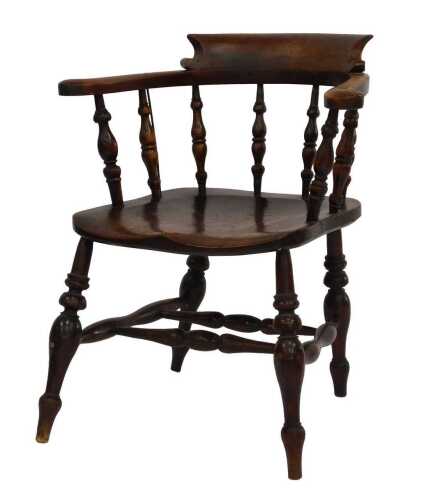 A late 19thC beech and elm captain's type chair, with solid seat and turned legs with double H stretcher.