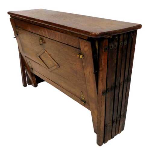 An early 20thC oak campaign bed, the front with brass open handle, above raised diamond decoration, 50cm high, 78cm wide.