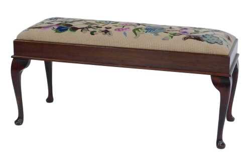 An early 20thC mahogany duet stool, the top with a floral tapestry seat, on cabriole legs with pad feet, 43cm high, 93cm wide, 36cm deep.