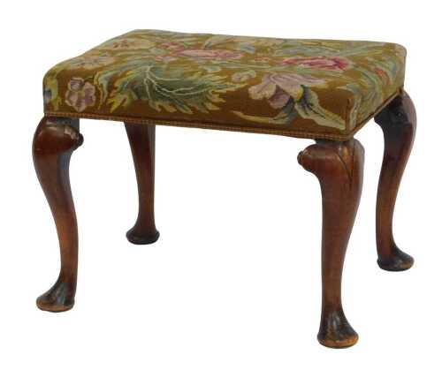 A Georgian mahogany stool, with floral embroidered seat, on four cabriole legs with pad feet, 44cm high, 54cm wide, 43cm deep.