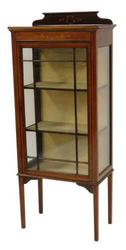 An Edwardian mahogany and inlaid display cabinet, the top with a raised back with swag and painted wreath decoration, above a panelled glazed door and sides, enclosing three shelves, on square tapering legs, 145cm high, 61cm wide, 29cm deep.