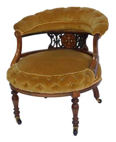 A Victorian rosewood and marquetry nursing chair, with button upholstered overstuffed back, above a pierced and ivory inlaid section, overstuffed button seat on turned tapering legs, on castors, 62cm high.