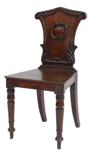 A 19thC mahogany hall chair, with a shaped and carved back, solid seat, on front turned legs.