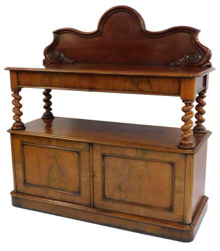 A Victorian mahogany buffet, with a shaped and carved back, over two cushion drawers, raised on barley twist supports, above two cupboard doors, raised on a plinth base, 145cm high, 136cm wide, 53cm deep.