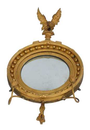 A 19thC giltwood girandole, of circular form, with roundel decoration surmounted by an eagle in flight, the base with twisted tassel decoration with two candle holders, 92cm high.
