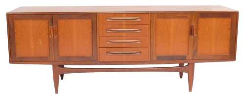 A mid century G-Plan Brasilia teak sideboard, the rectangular top above four central drawers flanked by two pairs of cupboards, on tapering legs united by stretcher, 80cm high, 205cm wide, 45cm deep. Upon initial inspection there is a mark to the front of