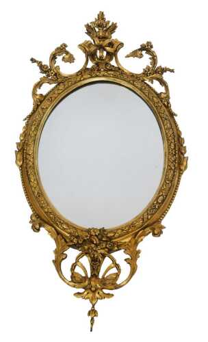 A 19thC giltwood wall mirror, ornately decorated with flowers, leaves, scrolling motifs, acorns, etc., 112cm high.