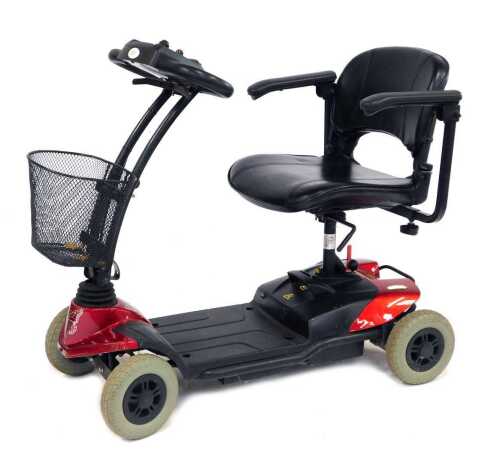 A ST Strider mobility scooter, in red trim, with charging cable and key.