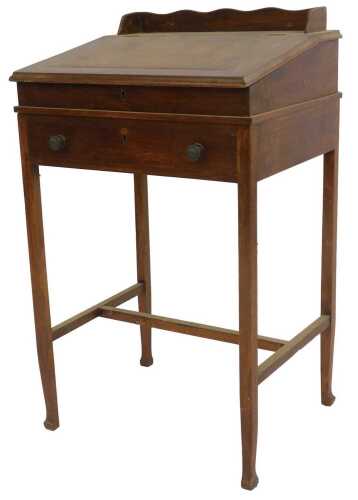 A late Victorian mahogany clerk's desk, the hinged lid opening to reveal a vacant interior, above a frieze drawer, raised on tapering square legs, united by an H stretcher, 87cm high, 51cm wide, 42cm deep.