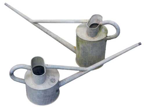 Two galvanised watering cans, with extended spouts, smallest bearing label for Hawes.